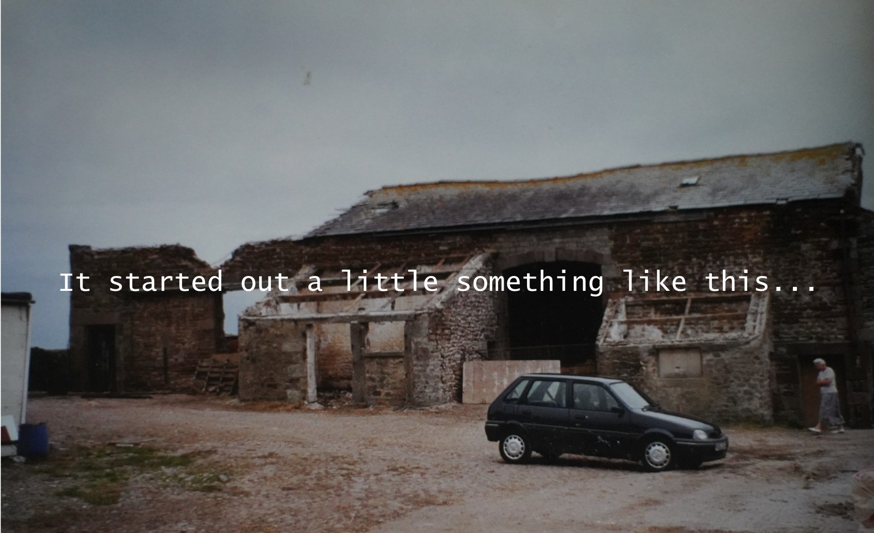 Stone barns and a parked car in the original courtyard, with the words ‘It started out a little something like this’ across the photograph