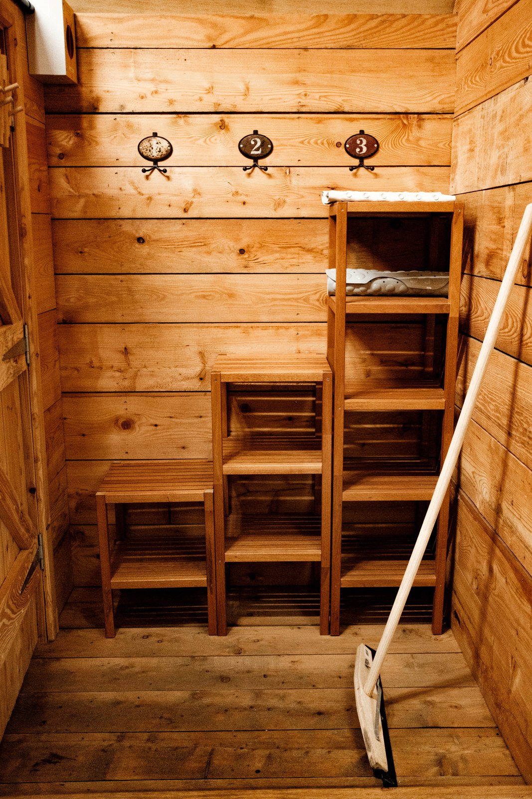 Hooks and wooden shelves in the shared changing area