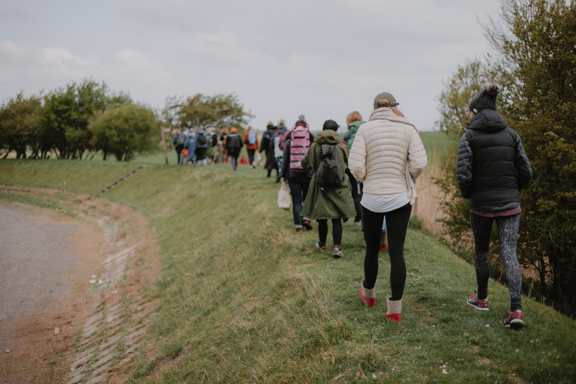A group walking together along a grassy coastal path
