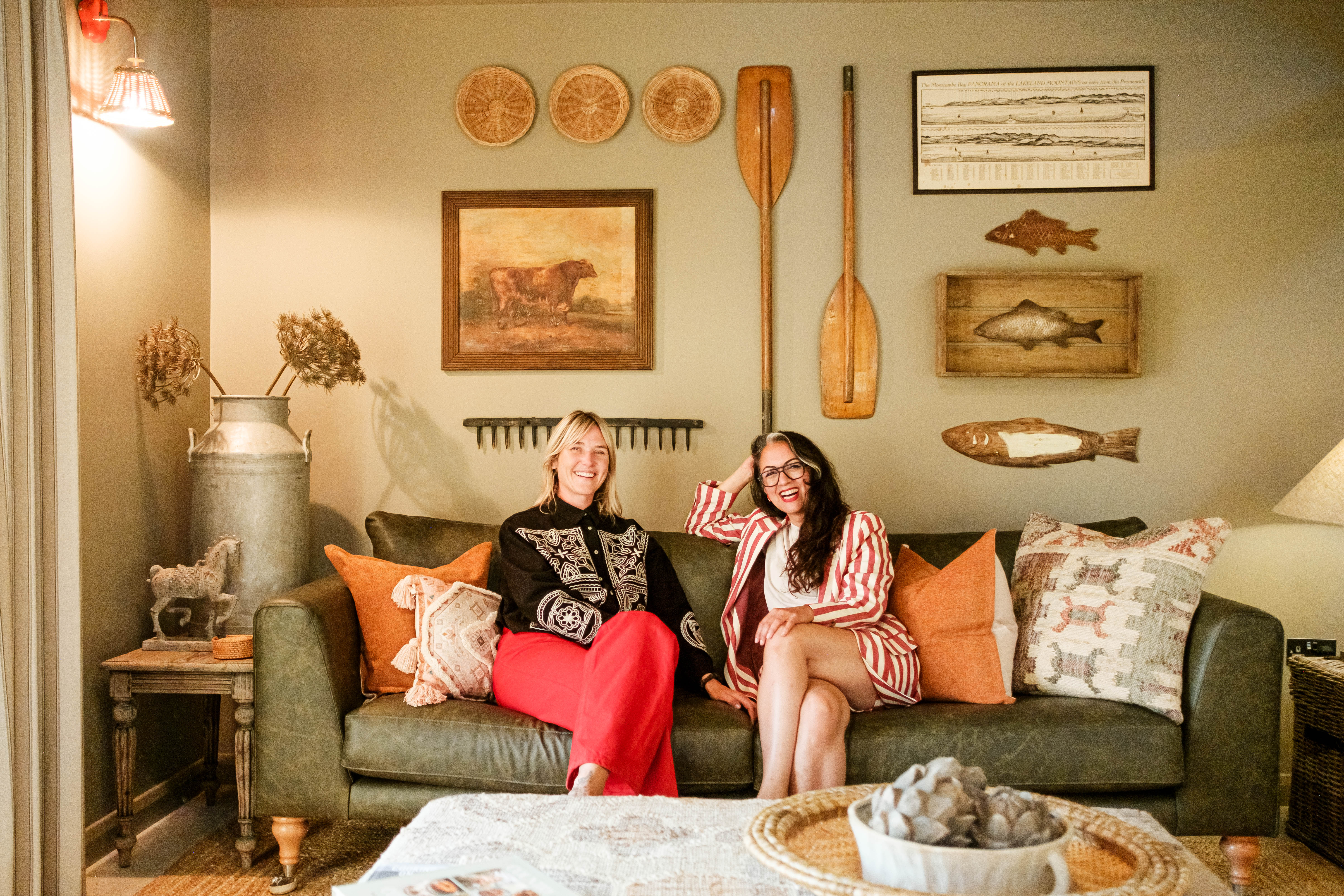 Michelle and Rita Millat sitting together on a green sofa at Patty’s Barn